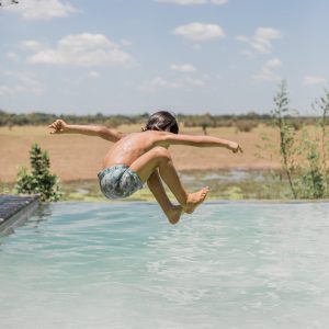 Kid jumping in pool